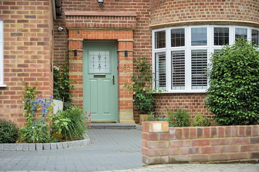 Brick house with green entrance door