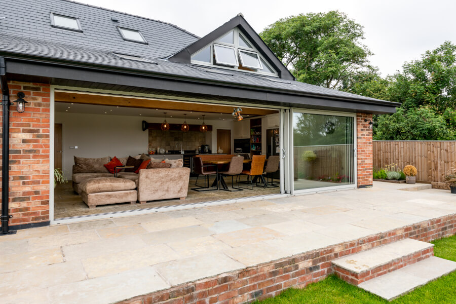 Open wall using sliding doors achieving an open space where the living room becomes the garden and the garden becomes the living room