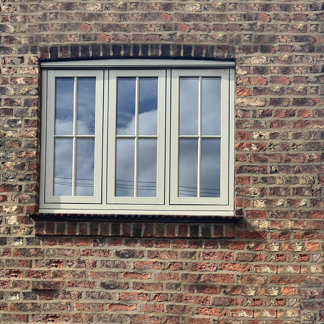 Close-up of a pebble grey Timberlook flush sash window installed