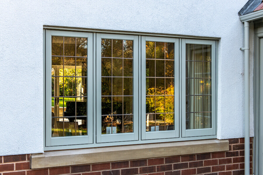 Flush Sash windows in light green installed on a house